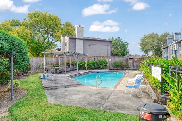 a view of a swimming pool with a patio