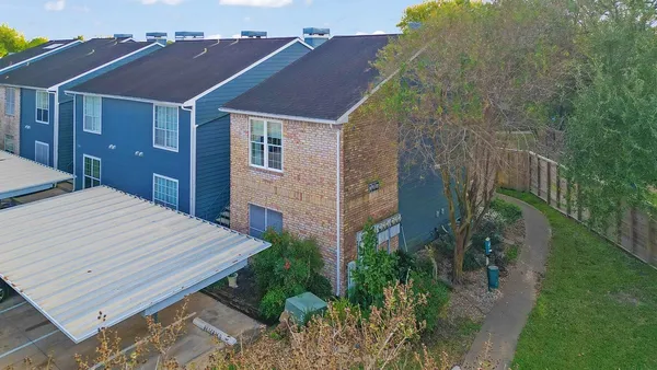 a aerial view of a house with a yard