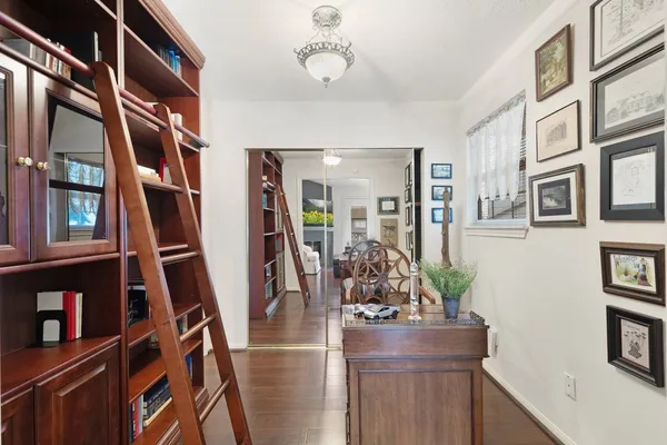 a living room with furniture and a book shelf