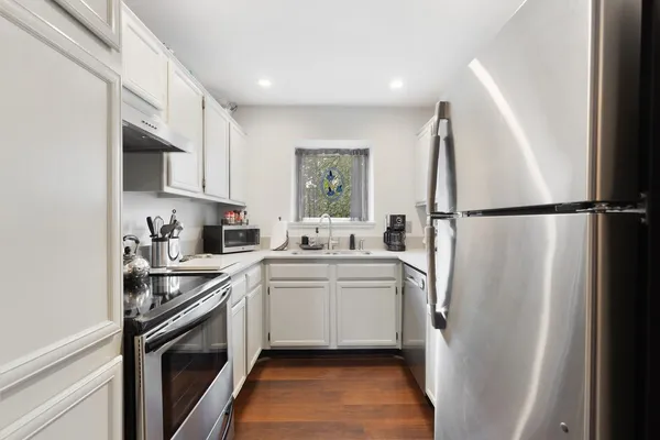 a kitchen with a sink a refrigerator a washer and dryer