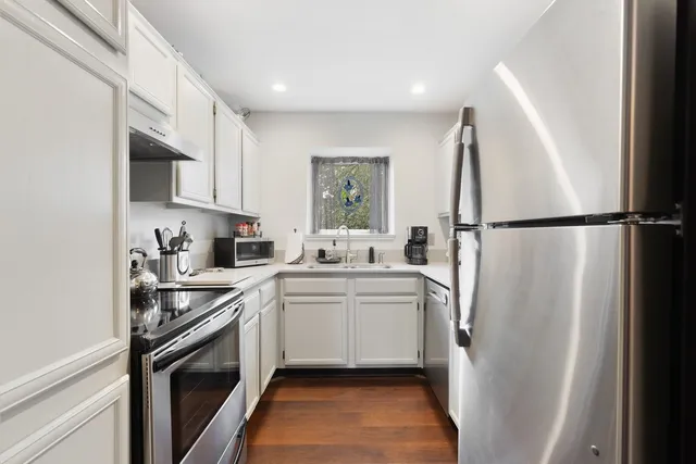 a kitchen with a sink a refrigerator a washer and dryer