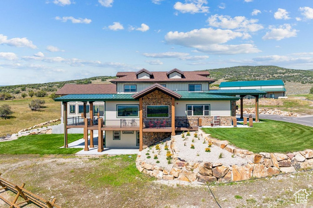 6117 North Rocky Ridge Road Peoa, UT 84061 - Photo 27 of 83 View of front of home with a patio, a front yard, and a deck