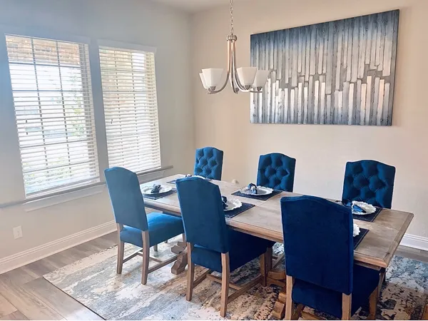 a view of a dining room with furniture and a window
