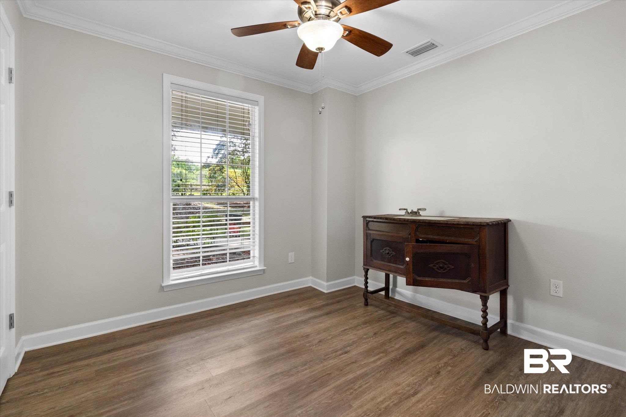 3715 Latigo Road Mobile, AL 36695 - Photo 12 of 39 Empty room featuring wood finished floors, ornamental molding, baseboards, and ceiling fan