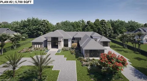 a aerial view of a house next to a yard