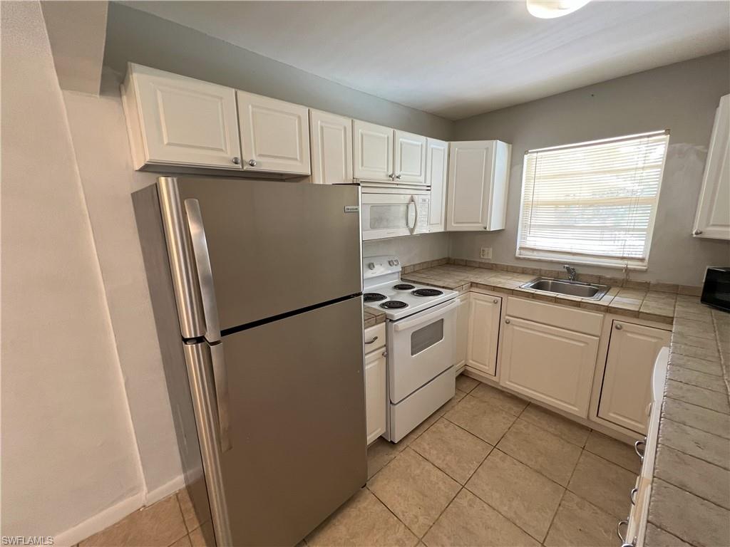 a white refrigerator freezer sitting in a kitchen