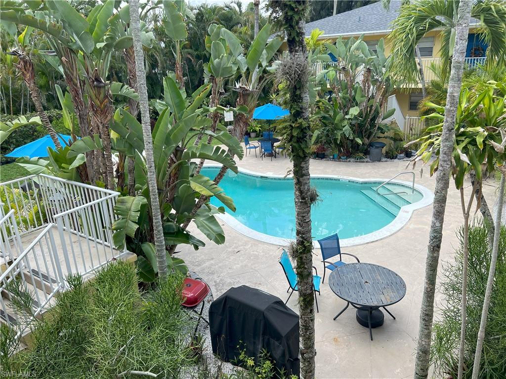 4290 Gulfstream Drive, Unit 16 Naples, FL 34112 - Photo 4 of 11 a backyard of a house with lots of green space and fountain