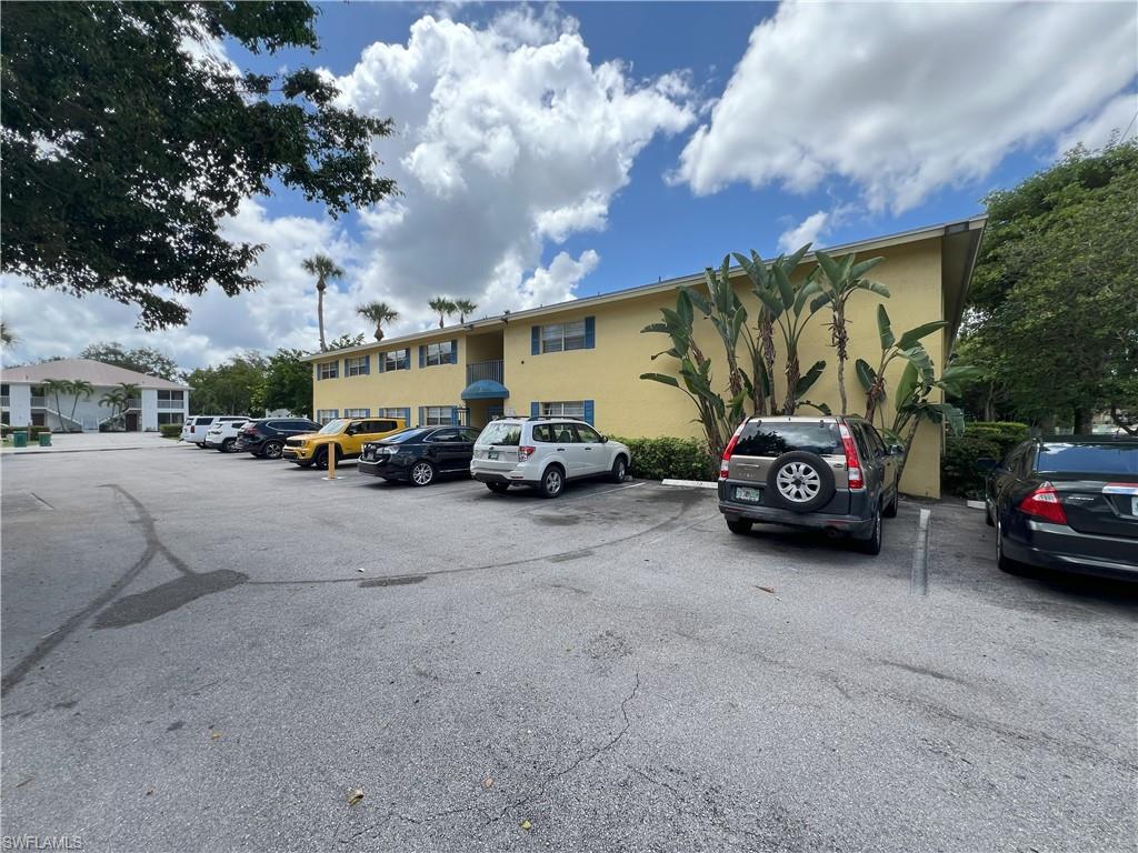 4290 Gulfstream Drive, Unit 16 Naples, FL 34112 - Photo 5 of 11 a view of a cars parked in front of a building