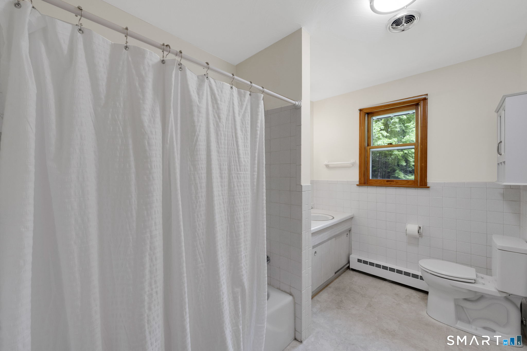 158 Notch Road Granby, CT 06035 - Photo 16 of 40 a bathroom with a toilet a sink and a window