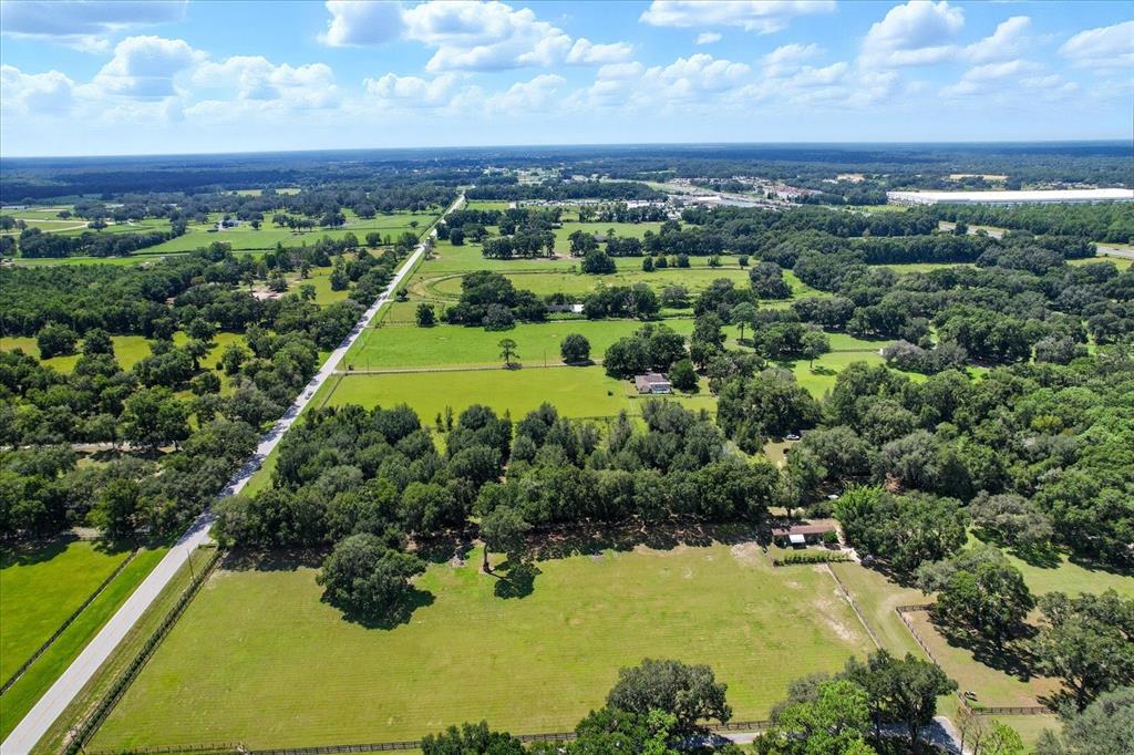 12550 Southwest 16th Avenue Ocala, FL 34476 - Photo 2 of 63 a view of a yard with large trees