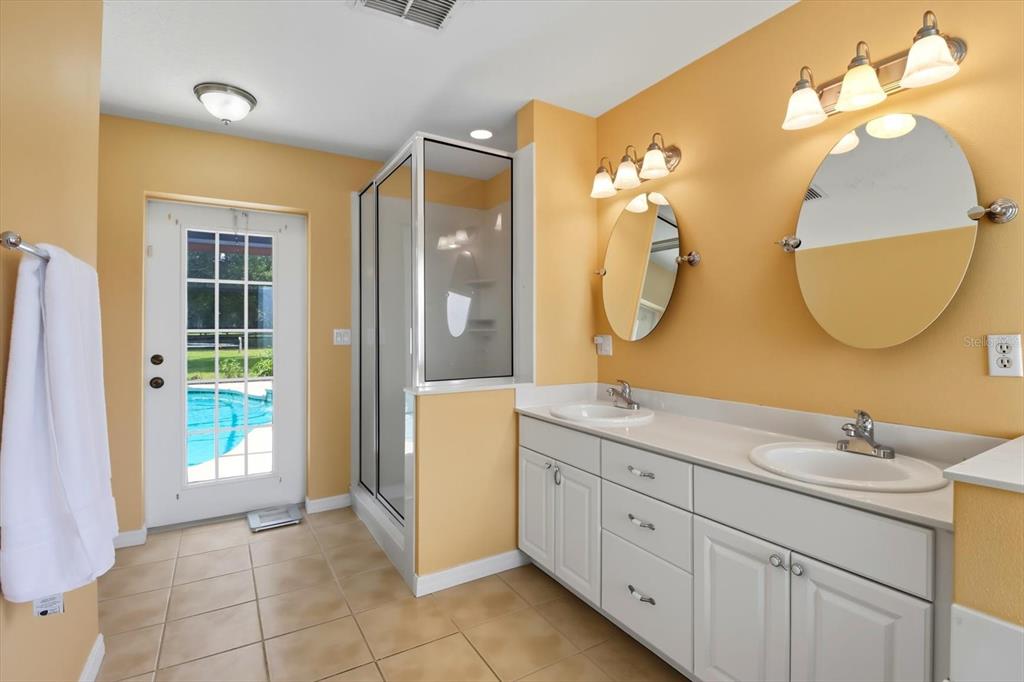 12550 Southwest 16th Avenue Ocala, FL 34476 - Photo 21 of 63 a spacious bathroom with a double vanity sink and a mirror