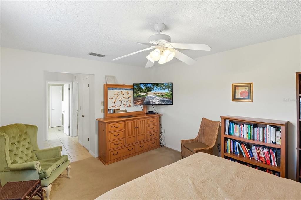 12550 Southwest 16th Avenue Ocala, FL 34476 - Photo 27 of 63 a bedroom with furniture and a book shelf