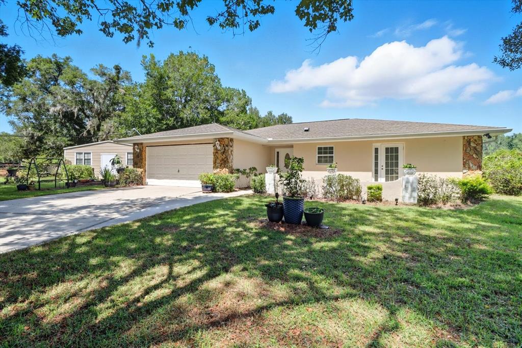 12550 Southwest 16th Avenue Ocala, FL 34476 - Photo 3 of 63 a view of backyard of the house with outdoor seating