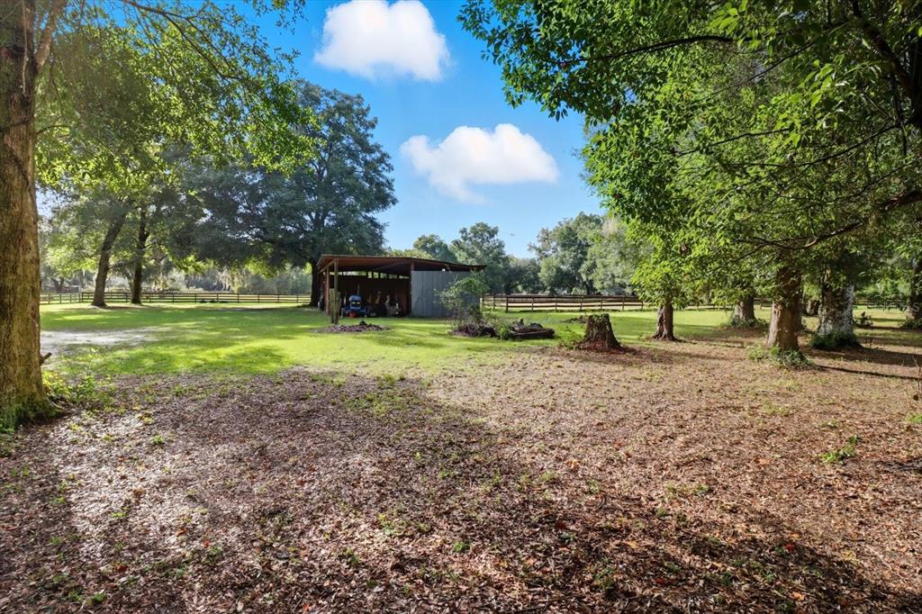 12550 Southwest 16th Avenue Ocala, FL 34476 - Photo 37 of 63 a view of outdoor space with garden and trees