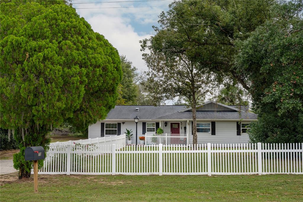 a front view of a house with a garden