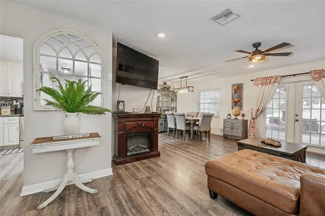 a living room with furniture a fireplace and a flat screen tv