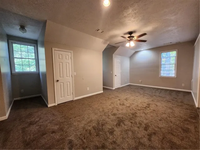 a bathroom with a granite countertop sink toilet a large mirror and shower