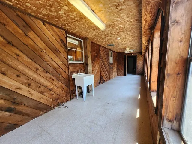a view of balcony with wooden floor and fence