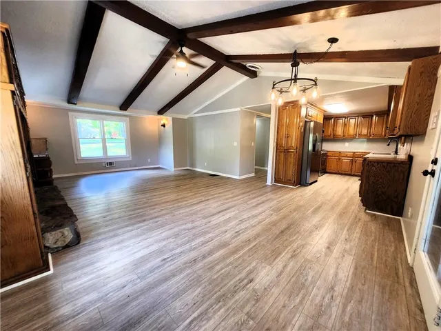 a view of a room with wooden floor