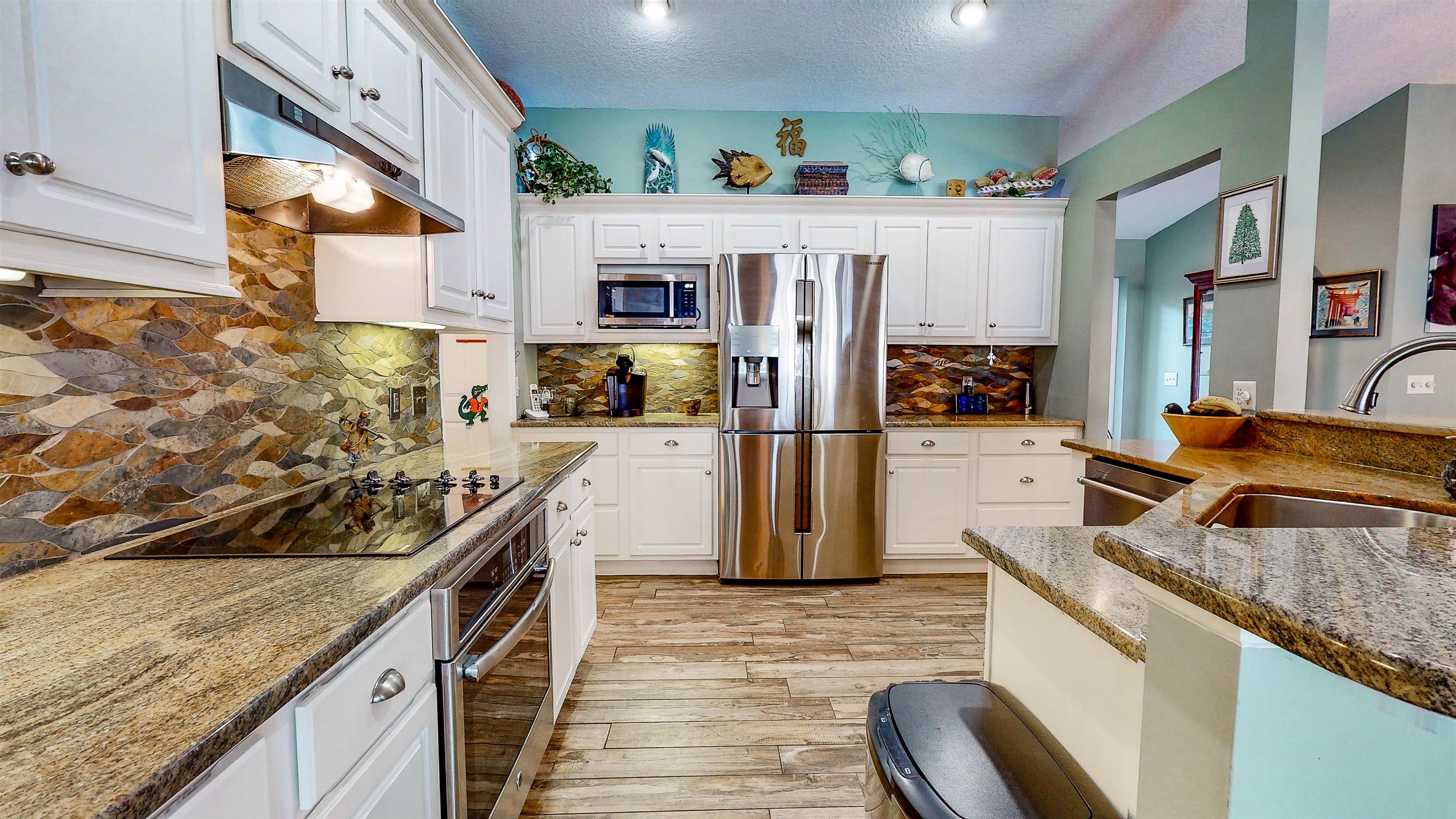 252 Desoto Road St. Augustine, FL 32080 - Photo 21 of 50 a kitchen with stainless steel appliances granite countertop a sink and cabinets