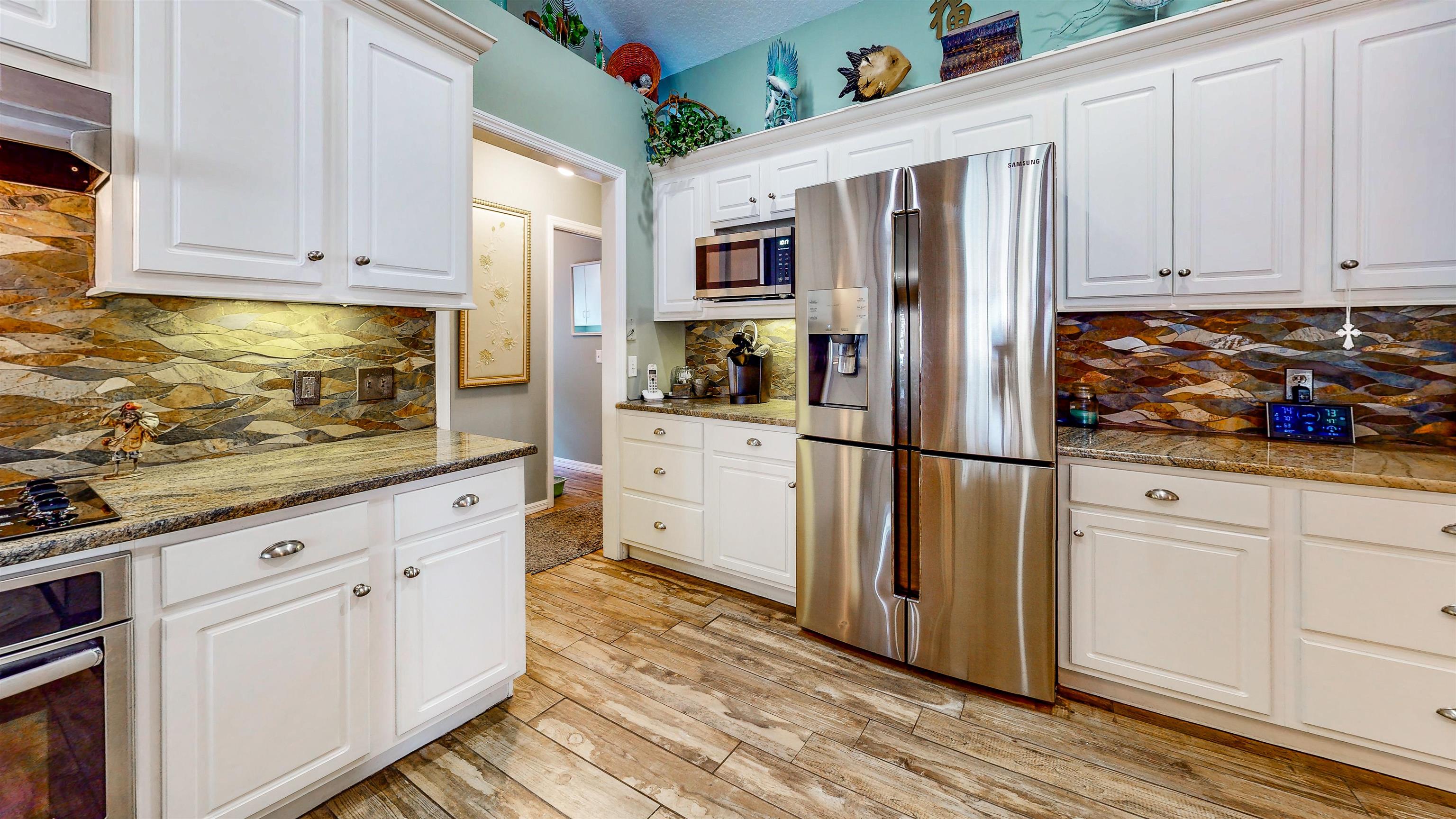 252 Desoto Road St. Augustine, FL 32080 - Photo 23 of 50 a kitchen with stainless steel appliances granite countertop a refrigerator and a stove top oven