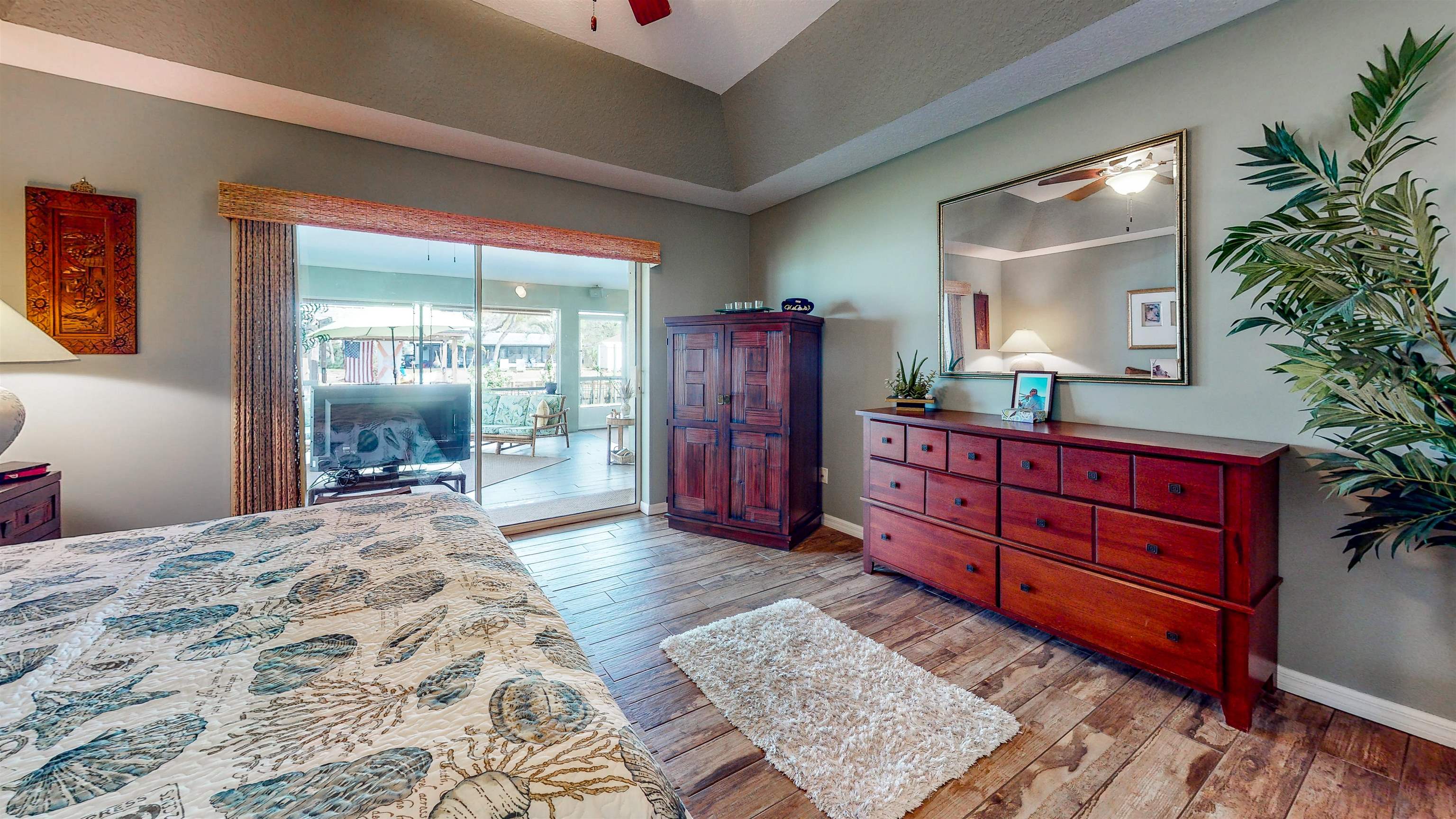 252 Desoto Road St. Augustine, FL 32080 - Photo 26 of 50 a bedroom with a large bed and wooden floor