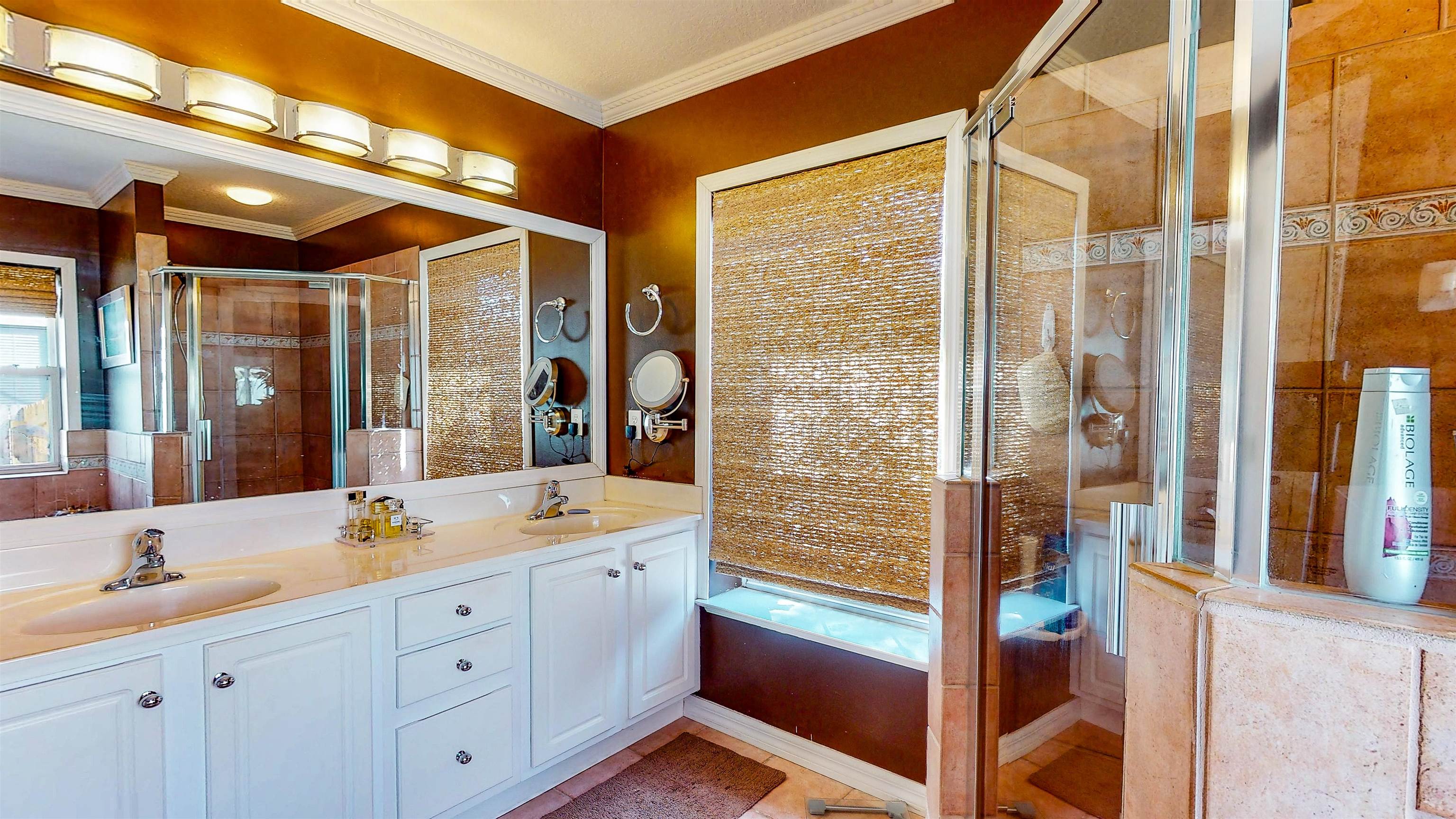 252 Desoto Road St. Augustine, FL 32080 - Photo 29 of 50 a bathroom with a double vanity sink a mirror and a shower