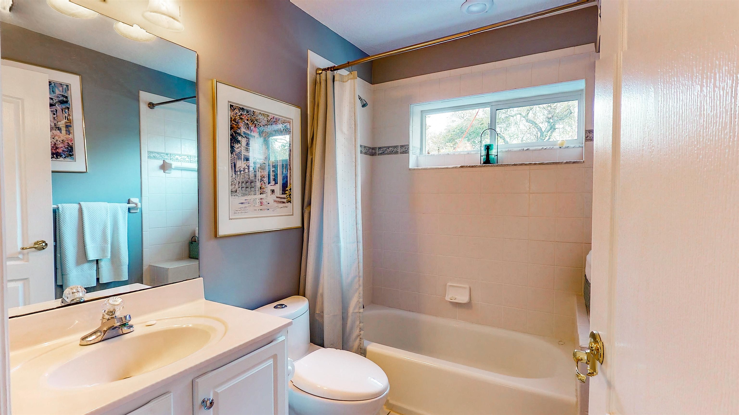 252 Desoto Road St. Augustine, FL 32080 - Photo 34 of 50 a bathroom with a bathtub shower sink vanity mirror and toilet