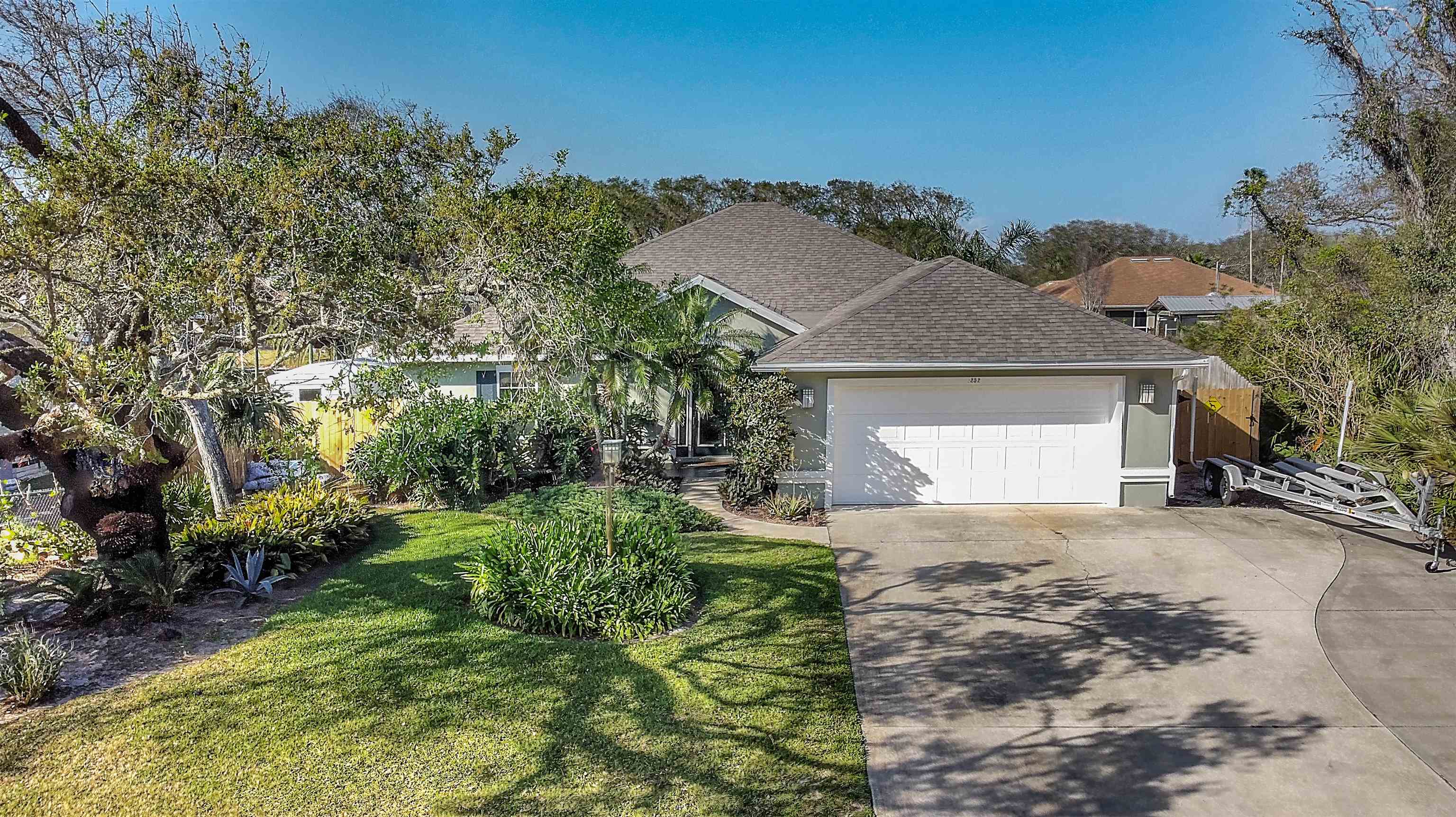 252 Desoto Road St. Augustine, FL 32080 - Photo 50 of 50 a front view of a house with a yard and garage