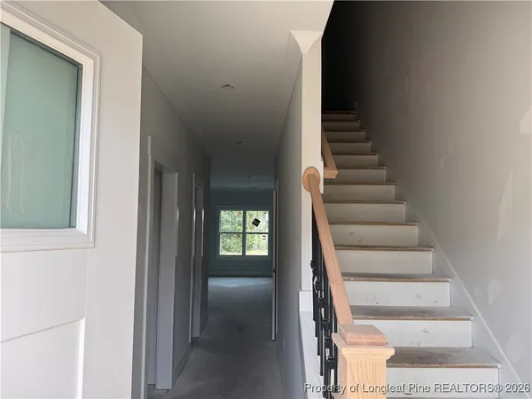 a view of entryway and hall with wooden floor