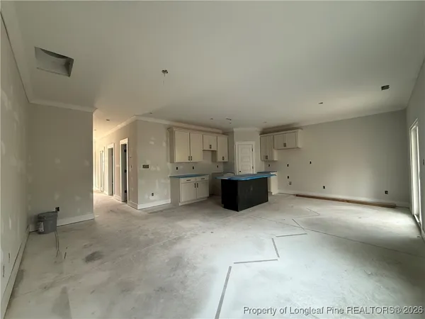 a kitchen with stainless steel appliances a sink a stove a refrigerator and cabinets