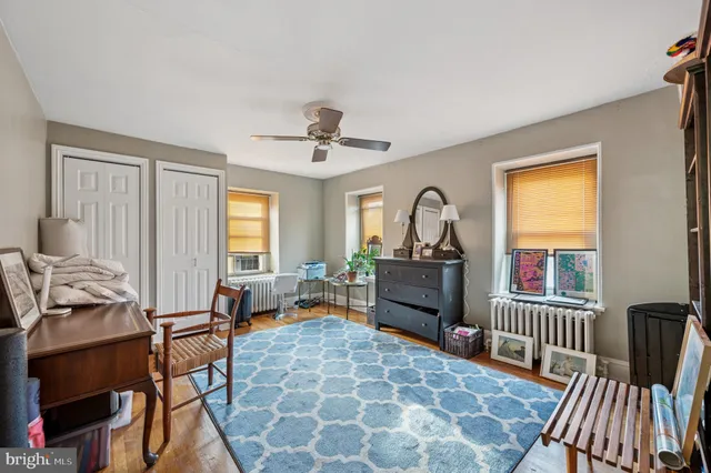 a living room with furniture a potted plant and a table