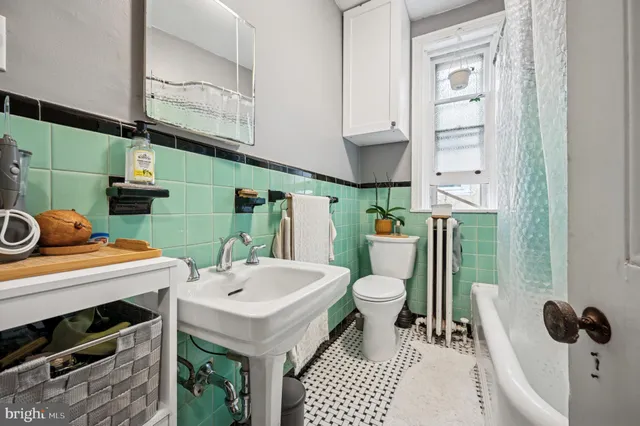 a bathroom with a toilet sink and mirror