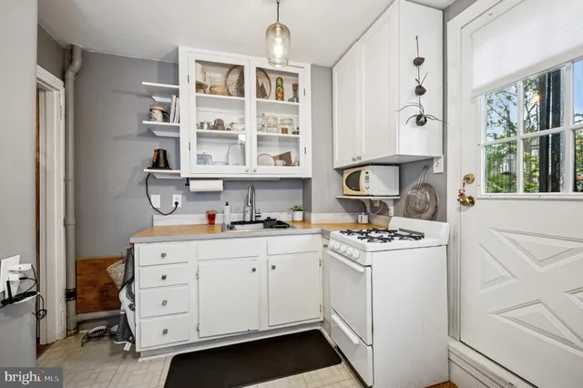 a view of a kitchen with workspace and a window