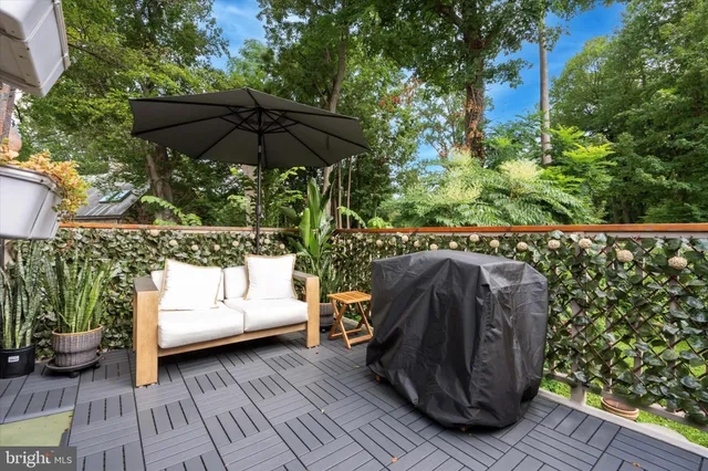 a view of a chair and tables in the back yard of a house