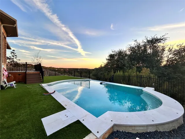 a swimming pool with outdoor seating and yard