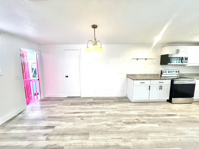 a kitchen with stainless steel appliances granite countertop a sink and a stove