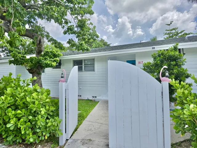a view of a house with a yard and plants