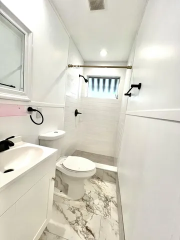 a view of a room with wooden floor and white walls