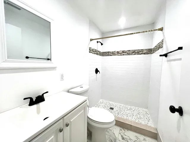 a view of a bedroom with wooden floor and windows