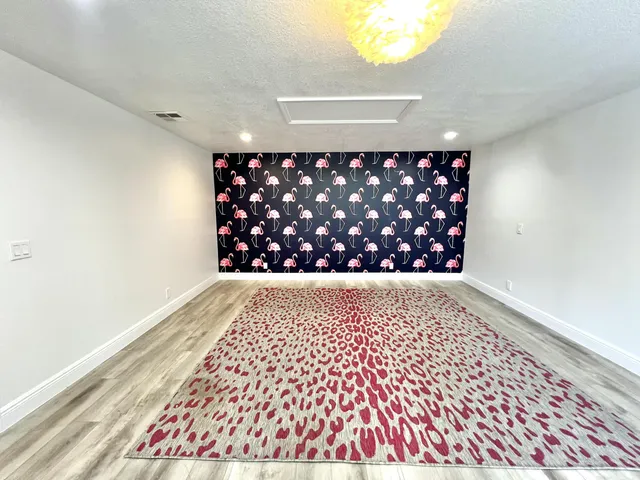 a white house with a flower garden in front of it