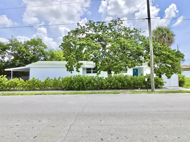a view of backyard with swimming pool and outdoor seating