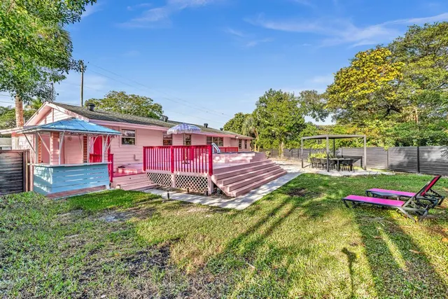 an aerial view of residential houses with outdoor space and trees
