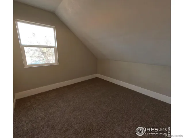 a bedroom with a bed and a book shelf