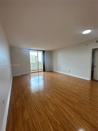 a view of wooden floor and windows in a room