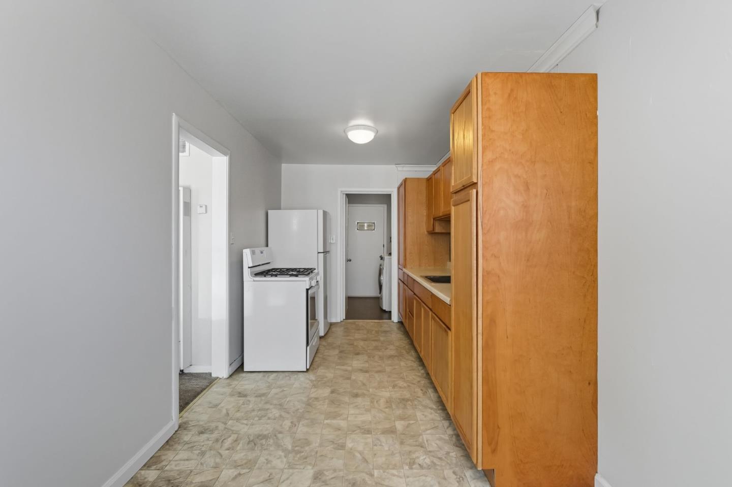317 Perrymont Avenue San Jose, CA 95125 - Photo 11 of 25 a view of a kitchen with a sink and refrigerator