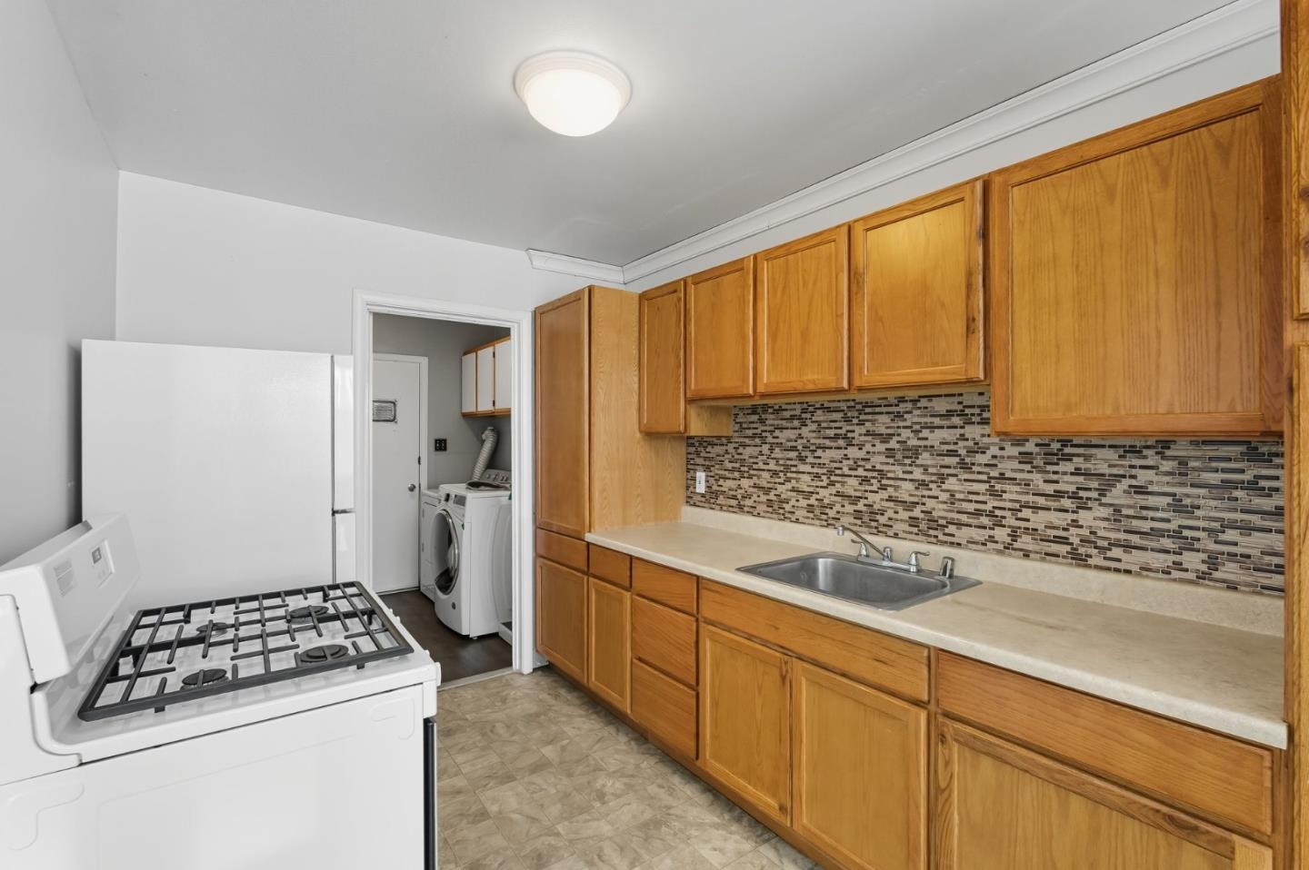 317 Perrymont Avenue San Jose, CA 95125 - Photo 12 of 25 a kitchen with sink cabinets and window