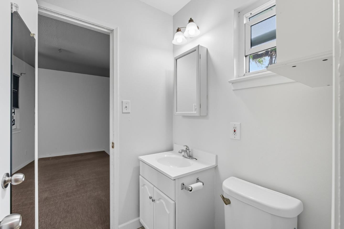 317 Perrymont Avenue San Jose, CA 95125 - Photo 15 of 25 a bathroom with a toilet sink and mirror