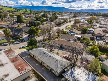 an aerial view of a house with a yard