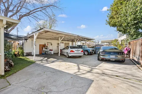 a view of cars parked in front of a house